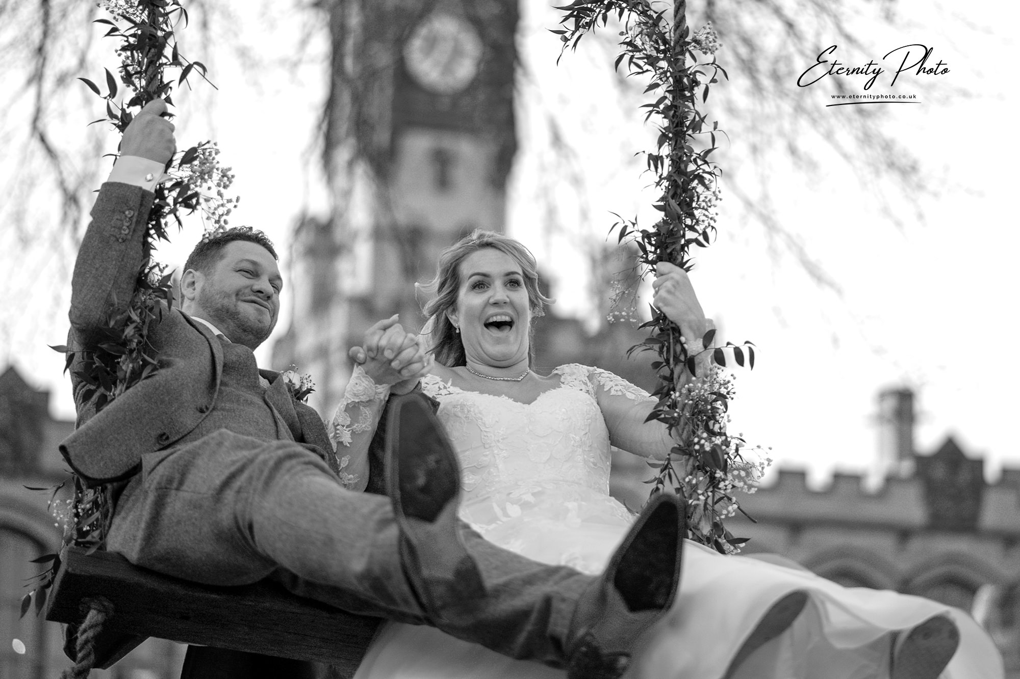 Joyful couple on swing at wedding event