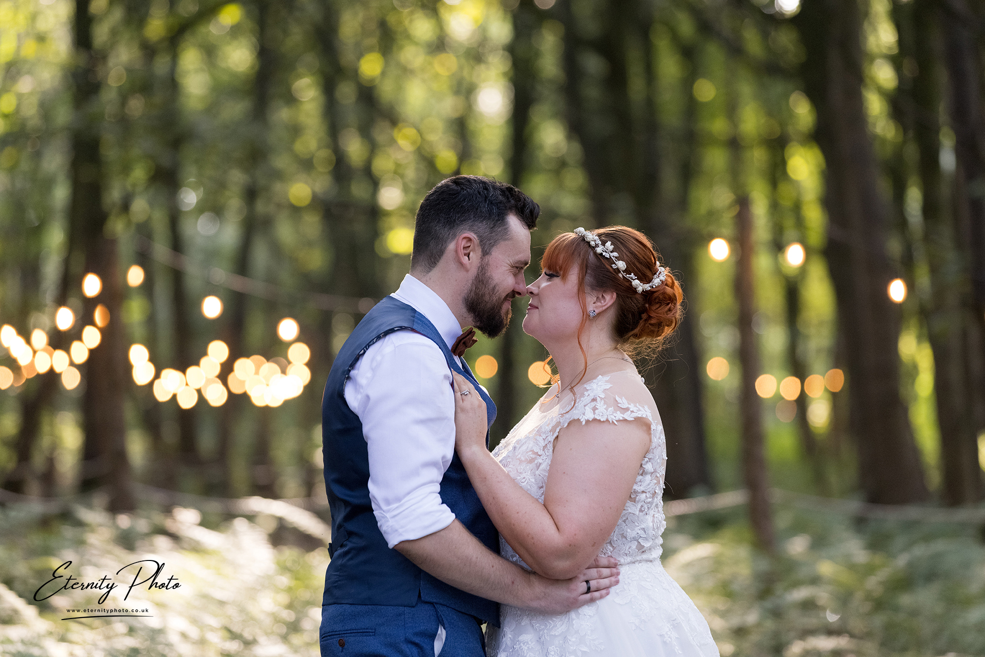 Bride and groom embracing in forest wedding