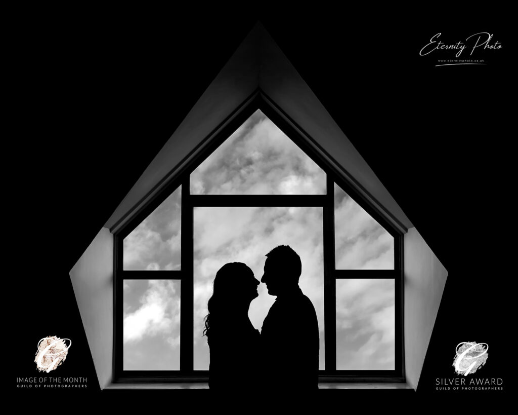 Silhouetted couple at window, romantic moment, silhouette photography.